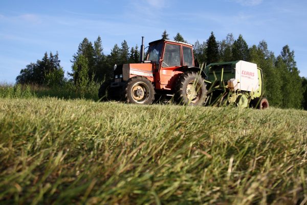 Valokuvassa traktori pellolla.