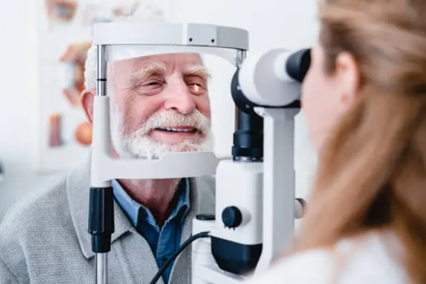 Valokuva, jossa optometristi tutkii potilaan silmiä.